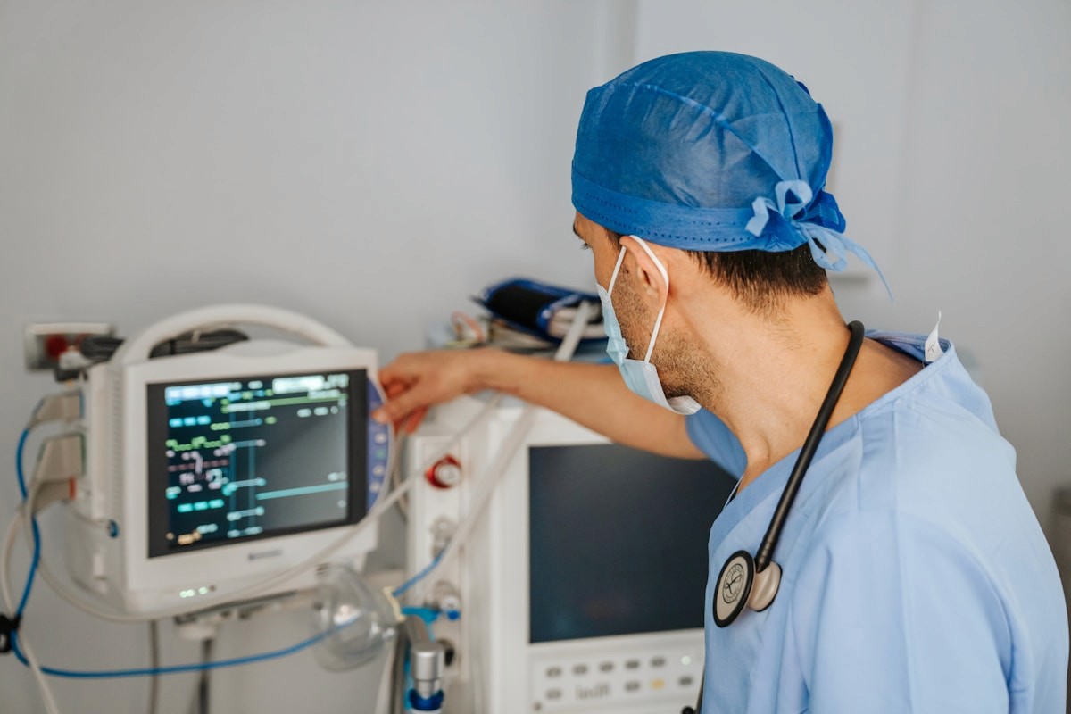 Clinician checking a patient monitor in a hospital